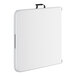 A white rectangular plastic folding table with a black handle.