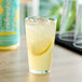 A glass of Smartfruit Restart Lemonade with a lemon slice in it.