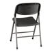 A Lancaster Table & Seating black folding chair with a charcoal seat and legs.