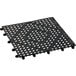 A black plastic interlocking bar mat with holes.