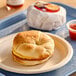 A Jimmy Dean ham, egg, and cheese breakfast sandwich on a plate.