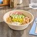 A bowl of food with rice, vegetables, and shrimp in a Tellus Products Elite coated fiber bowl.