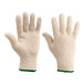 A close-up of a pair of Lavex white knit gloves with green trim.