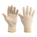 A close-up of a pair of white Lavex work gloves with yellow tips.