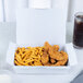 A white Southern Champion take-out container filled with fried chicken and french fries.