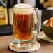 A glass of beer on a coaster.