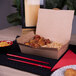 A Southern Champion #3 take-out box of food on a table.