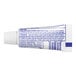 A close-up of a white Colgate toothpaste tube with blue text.