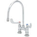 A silver T&S deck mount faucet with gooseneck spout and wrist action handles.