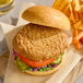 A plant-based vegan crispy chicken sandwich with lettuce, tomato, pickles, and a bun.