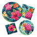 A set of Tropic Time paper napkins on a table with tropical party plates and flowers.