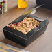 A black box of food from Southern Champion on a table.