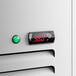 A white swing glass door merchandiser refrigerator with a digital temperature display and a green indicator light.