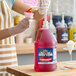 A gallon jug of Carnival King Strawberry Snow Cone Flavoring Syrup with a pump dispenser.