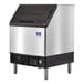 A silver and black Manitowoc NEO undercounter ice cube maker with full dice cubes.