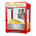 A red and silver Paragon Zenith countertop popcorn machine with "Fresh Popcorn" neon sign.