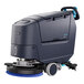 A Nilfisk walk-behind floor scrubber with wheels and a handle on a white background.