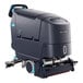 A Nilfisk SC550 cylindrical floor scrubber with wheels on it.