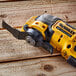 A yellow and black cordless DCS353B saw on a wood surface.