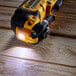 A yellow and black Dewalt cordless grinder with a light on it.