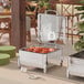 A table with two Acopa Manchester 2/3 size square chafers on stands with fuel holders.
