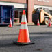A 28-inch orange heavy-duty PVC traffic cone with a 7 lb. base and double high-intensity prismatic collars.