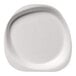 A close-up of a white Jungle Stone compostable sugarcane pulp plate with a curved edge.