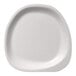A close-up of a Jungle Stone compostable sugarcane pulp plate with a rounded edge.