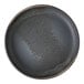A close-up of a Cloud Terre by Fortessa Volcanic Gray stoneware plate with a raised rim and speckled design.