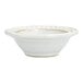 A Mannette Perls white stoneware bowl with a scalloped rim and embossed pearl edge.