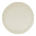 A round ivory melamine plate with a slightly irregular edge.