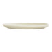 A round ivory melamine plate with a slightly irregular edge.