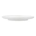 A close-up of a Cloud Terre by Fortessa Iceland white stoneware salad plate with a curved edge.