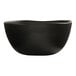 A black melamine soup bowl with a slightly irregular rim.