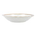 A Mannette Perls by Fortessa white stoneware bowl with an embossed pearl edge and gold trim.