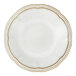 A close-up of a Mannette Perls white stoneware soup plate with an embossed pearl edge.