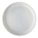 A close-up of a white Cloud Terre by Fortessa stoneware plate with specks.