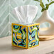 A close-up of a Kleenex Anti-Viral tissue box with a colorful design.
