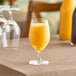 A glass of Nestle Vitality orange juice on a table.