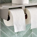 A roll of Scott 1000 toilet paper on a shelf.