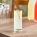 A glass of Nestle Vitality lemonade with ice and a lemon slice.