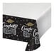 A white paper tablecloth with black and white text that says "Congratulations Graduate" and a black graduation cap.