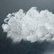 A pile of flake ice from a Follett undercounter ice machine on a table.