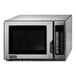 A silver Amana commercial microwave with a black door.