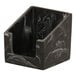 A black swirl resin beverage napkin holder on a counter.