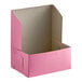 A pink Baker's Lane cake box with a lid open.