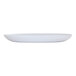 A matte white oval melamine platter on a white surface.