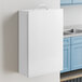 A white rectangular Medique first aid kit cabinet with a black border on the door.