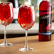 Two glasses of DaVinci Gourmet sugar-free raspberry-flavored red liquid with raspberries in them.