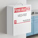 A white Medique first aid kit cabinet on a wall.